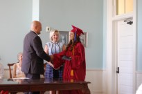 Sarah receives her diploma from Dr. Gates as President of the Board Joyce Gates looks on